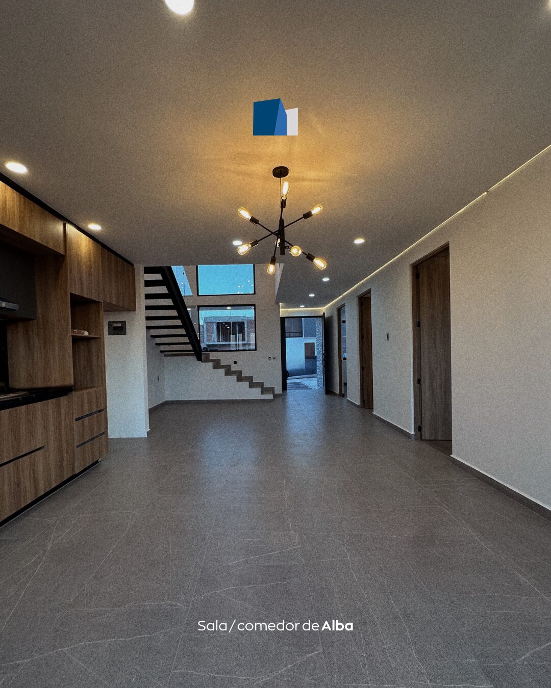 Open concept living and dining room with staircase at Casa Alba, modern home in Morelia, Michoacan