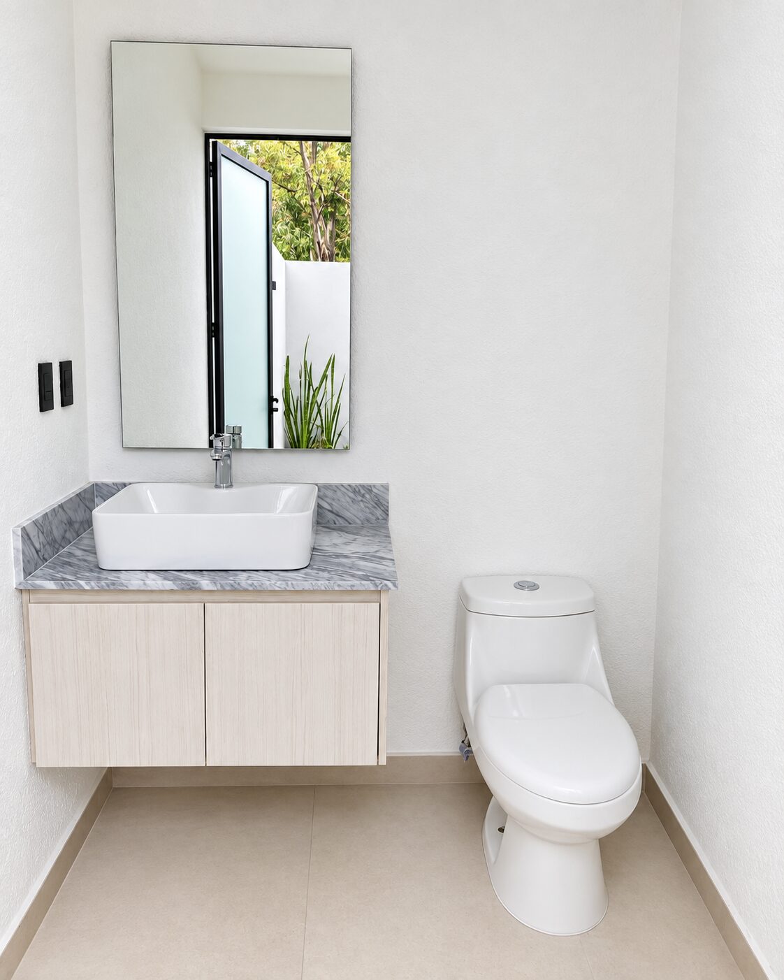 Half bathroom with mirror and granite countertop · Casa Magna by Mircon builders in Morelia