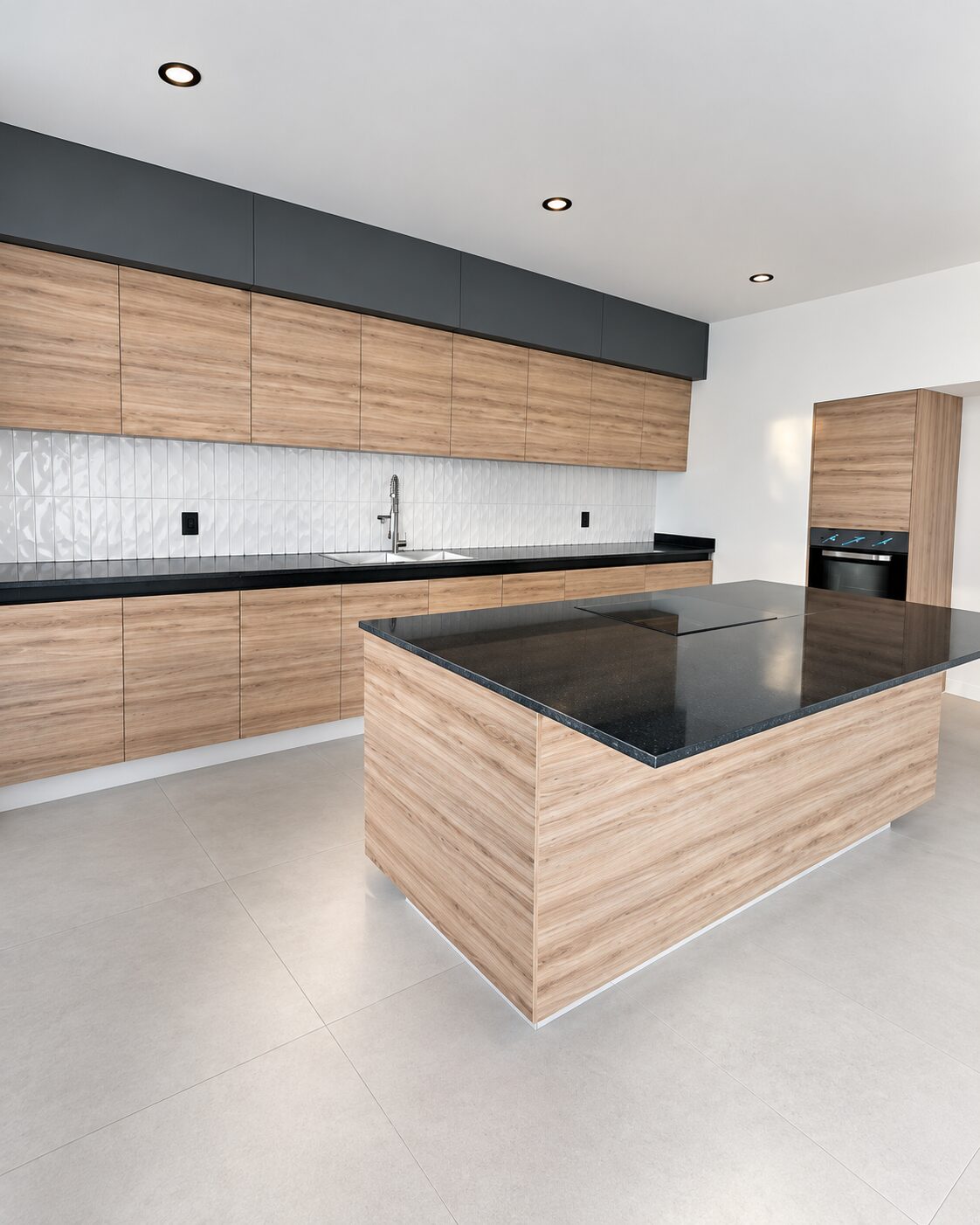 Fitted kitchen with black granite island and wood cabinets · Casa Magna, Mircon builders in Morelia