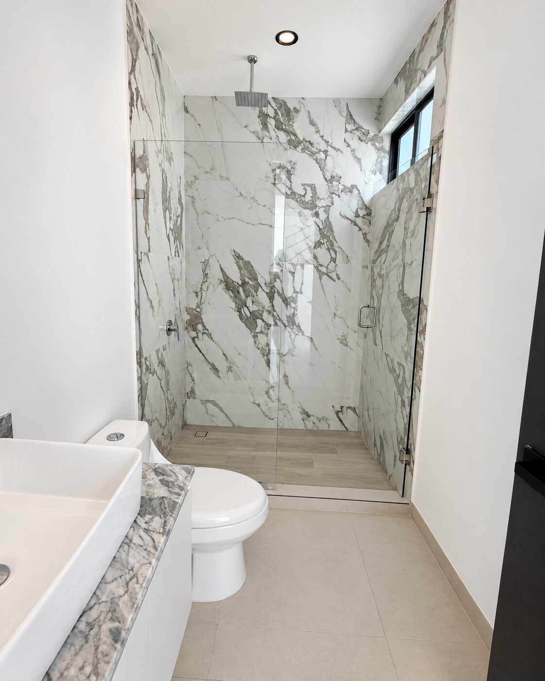 Bathroom with marble shower and glass enclosure · Casa Magna by Mircon builders in Morelia